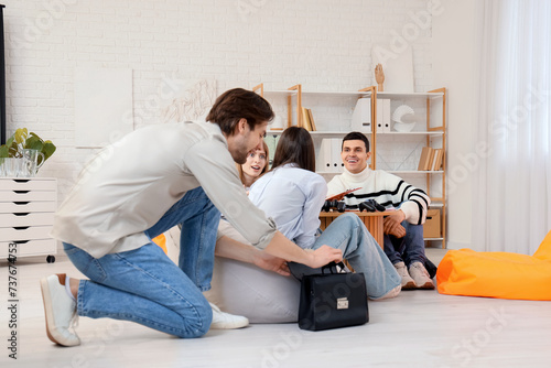 Young man putting toy spide...