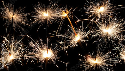 Glittering burning sparkler against blurred bokeh light background