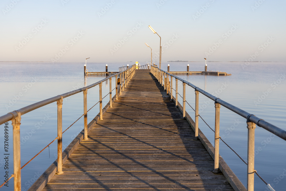 The Meningie jetty on a calm sunny morning on the Coorong at Meningie South Australia on October 2nd 2023