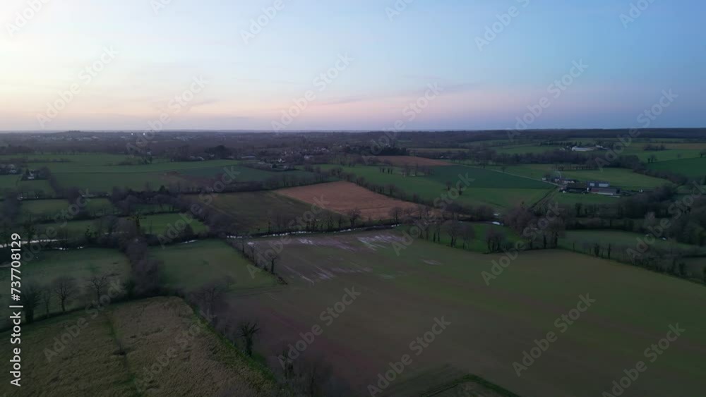 Acigné countryside at sunset and sky for copy space. Aerial backward Acigné countryside at sunset and sky for copy space. Aerial backward