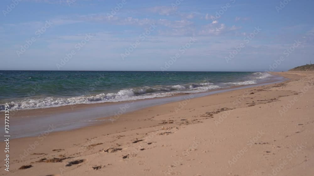 Waves Rolling Over The White Sand Beach Of Bunbury During Summer In Western Australia. Slow Motion Shot