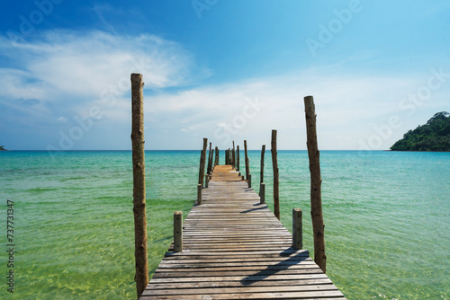 The wooden bridge in the sea at Koh Kood is a tropical island with emerald green water and beautiful beaches, in Koh Kood, Trat, Thailand. © Songsak C
