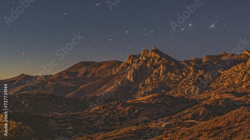 Starry Night Sky Over Illuminated Rocky Mountains