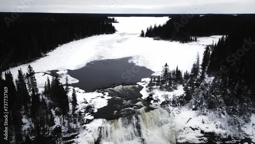 Slow Reveal 4K Drone In Shot of environment nature Tourism Travel Landmark frozen winter Water Pisew Kwasitchewan Falls Waterfall Provincial Park Thompson Manitoba Northern Arctic Canada Landscape photo