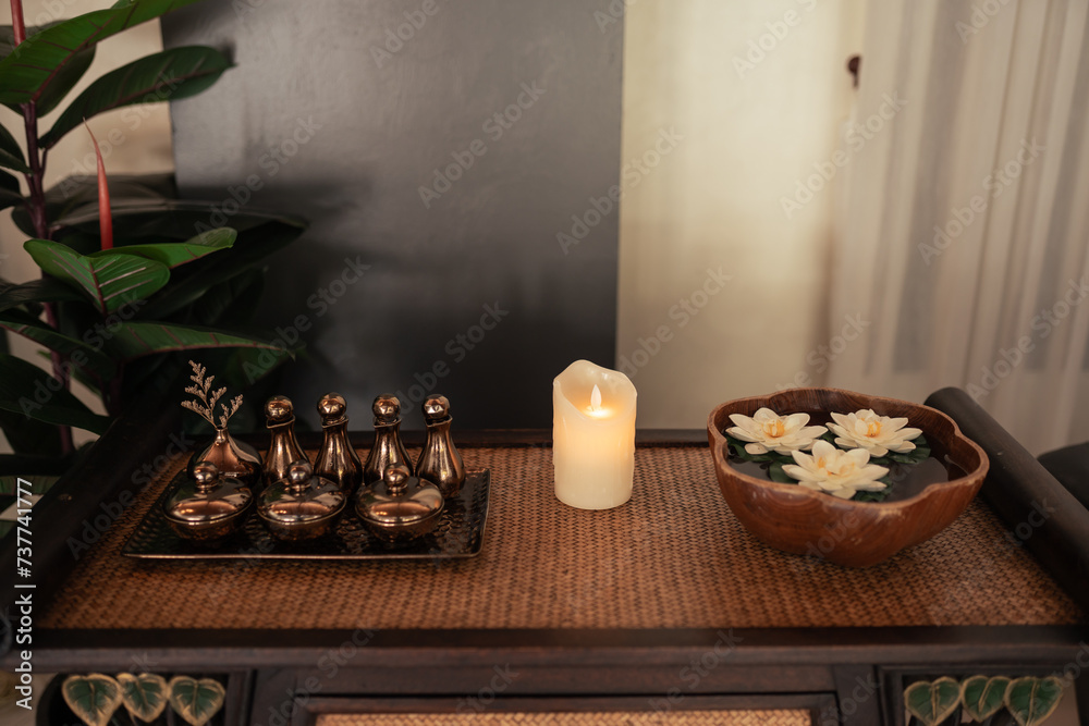Fototapeta premium Essential Aromatic oil and candle on trey wooden for aromatherapy.