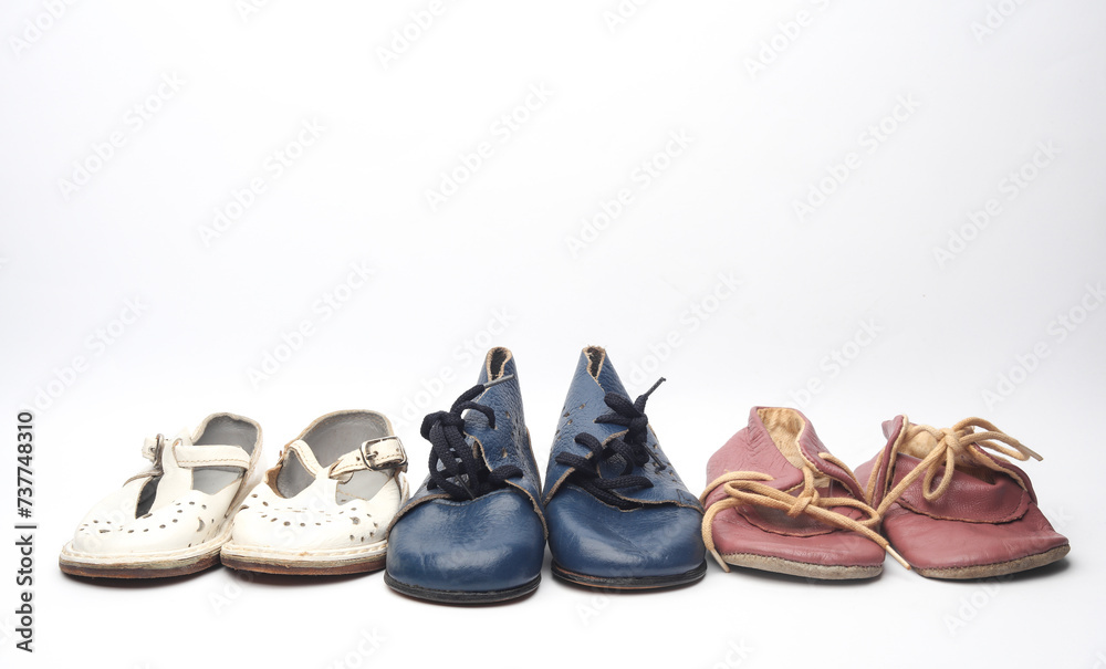 Fototapeta premium Children's retro used shoes on a white background