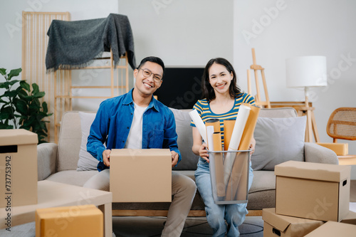 Happy asian young attractive couple man and woman with big boxes moving into a new house, new apartment for couple the new home, Moving house. .
