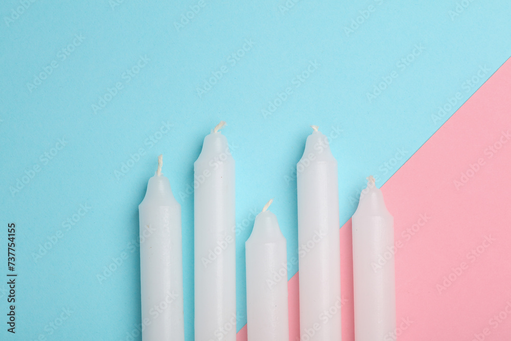 Set of wax candles on a blue pink background Set of wax candles on a blue pink background