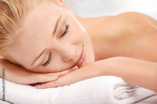 Relax, sleep and face of woman at spa for luxury holistic treatment, facial health and professional massage therapy. Self care, peace and refresh for girl on bed with body wellness, rest and hotel.