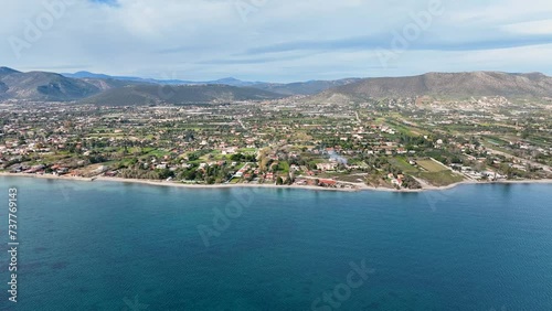 Flying towards the coastline with houses and agricultural land photo