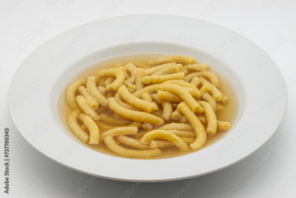 Italian Passatelli. Traditional Italian pasta cooked in broth. Bologna, Italy. Italian Passatelli. Traditional Italian pasta cooked in broth. Bologna, Italy.
