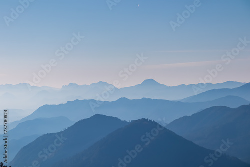 Panoramic view of magical mountain peaks of Karawanks and Julian Alps seen from Goldeck, Latschur group, Gailtal Alps, Carinthia, Austria, EU. Mystical atmosphere in Austrian Alps on sunny summer day. photo