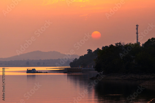 Sunset over the river.  Tawa Reservoir is a reservoir on the Tawa River in central India. It is located in Itarsi of Narmadapuram District of Madhya Pradesh, India. photo