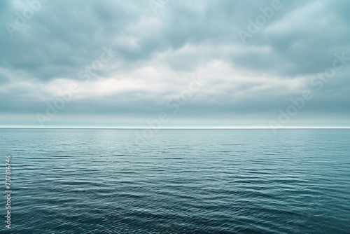 A photo showing a vast expanse of water under a cloudy sky, Calm sea horizon under minimal cloudy sky, AI Generated