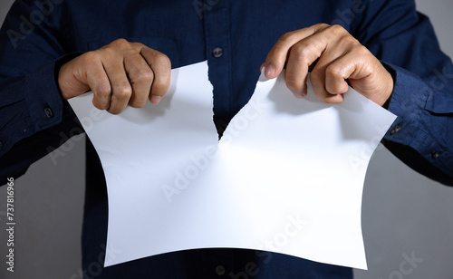Man tearing blank white paper into two parts. Isolated. With copy space.