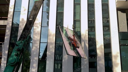 Window installation using a crane. Modern high rise building exterior. Close up