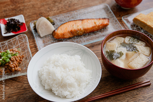 鮭の西京焼きと卵焼きと納豆と豆腐と油揚げとワカメのお味噌汁の家庭的な和朝食 photo