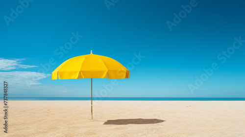 A yellow umbrella sitting on top of a sandy beach.
