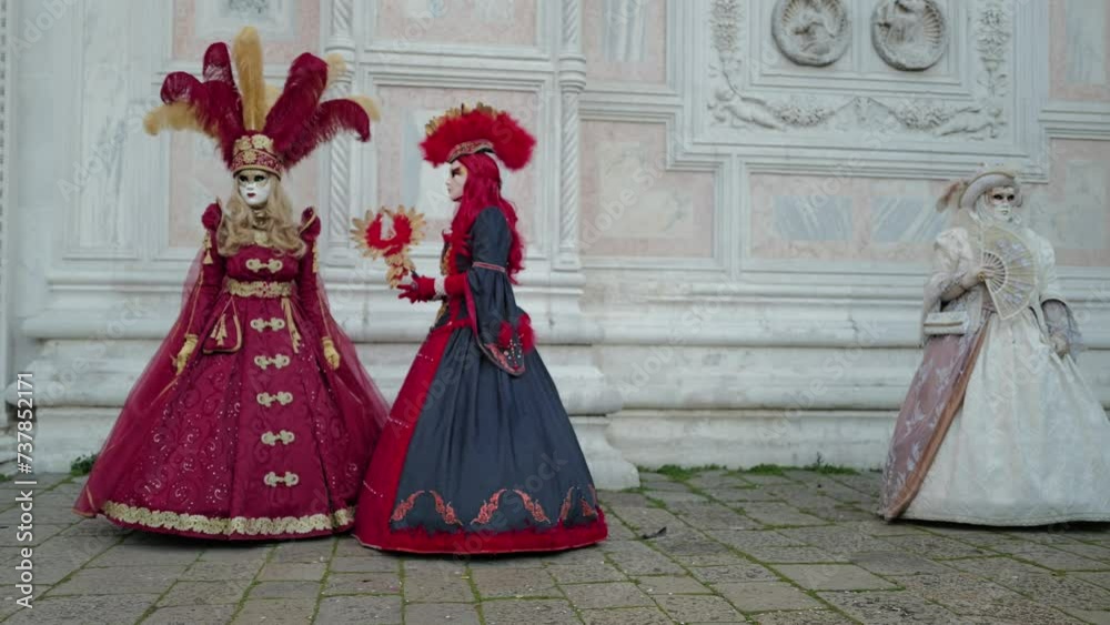 Venice, Italy - February 13, 2024 - carnival masks are photographed with tourists in San Marco square Venice, Italy - February 13, 2024 - carnival masks are photographed with tourists in San Marco square