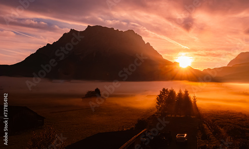 Foggy alpine sunrise view with Mount Zugspitze at Lermoos  Reutte  Tyrol  Austria