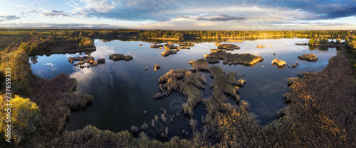 A drone photo of lake - pond bog with sun - Absolutely stunning aerial landscape sunset panorama.