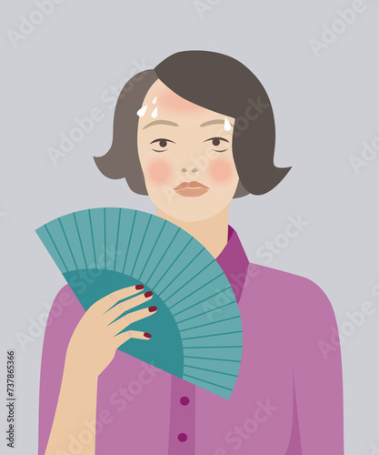 Woman using fan for hot flashes, menopause symptoms.