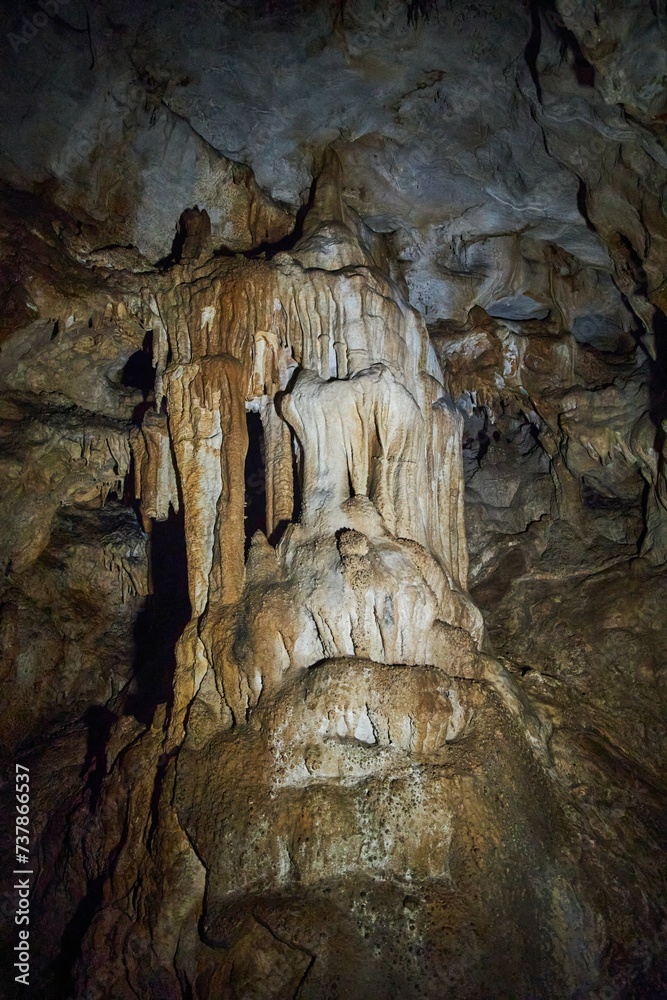 A wild cave inside. Stalactites and stalagmites. Speleology and surveys