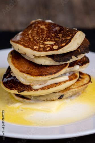 delicious cooked pancakes with cottage cheese and melted butter