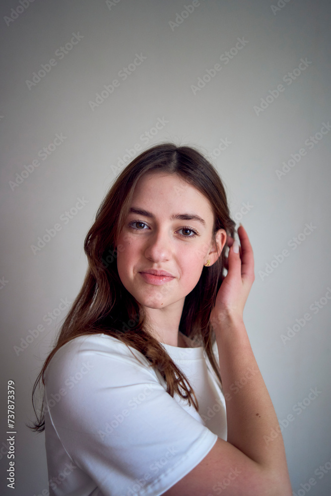 portrait of a beautiful teenage girl on a chair in a bright room in a minimalist style portrait of a beautiful teenage girl on a chair in a bright room in a minimalist style