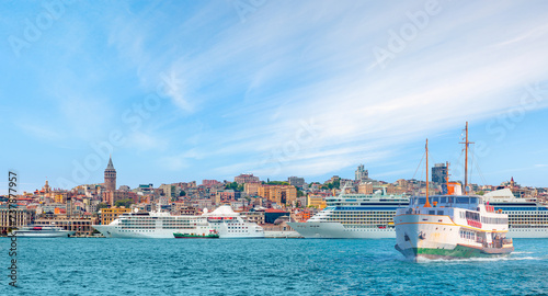 Cruise ship and ferry (steamboat)  traffic in the Bosphorus - Sea voyage with old ferry (steamboat) on the Bosporus - Coastal cityscape with modern buildings and Galata Tower - Istanbul, Turkey   © muratart