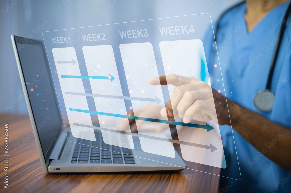 Doctor using laptop in office for weekly plan treatment patient and follow up in hospital