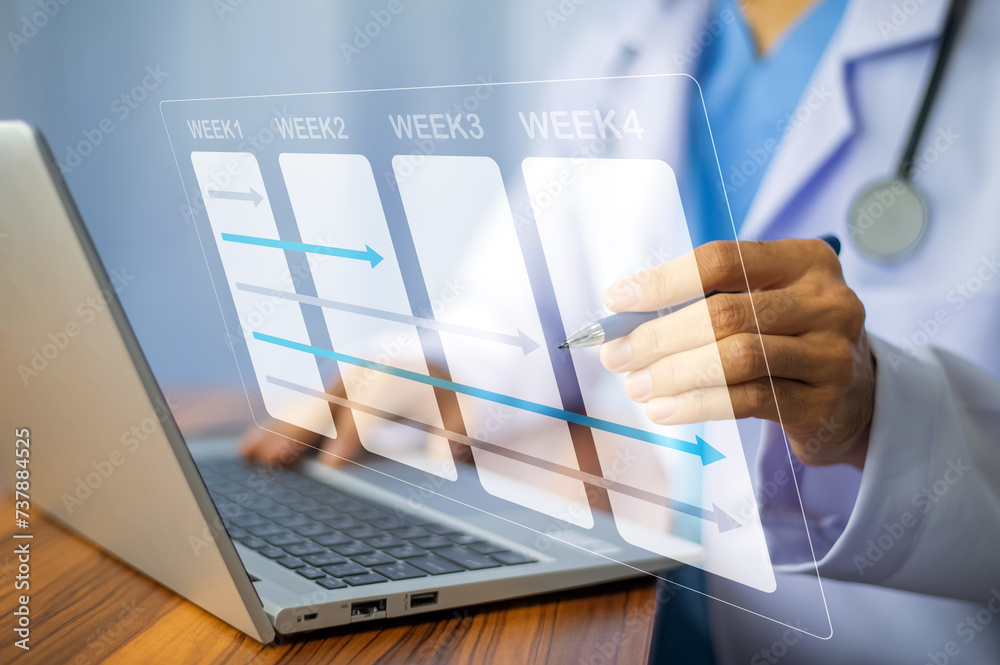 Doctor using laptop in office for weekly plan treatment patient and follow up in hospital