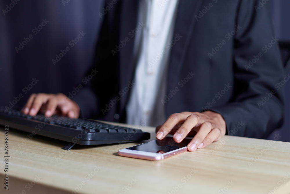 Businessman using mobile phone and computer business success concept.. Businessman using mobile phone and computer business success concept..