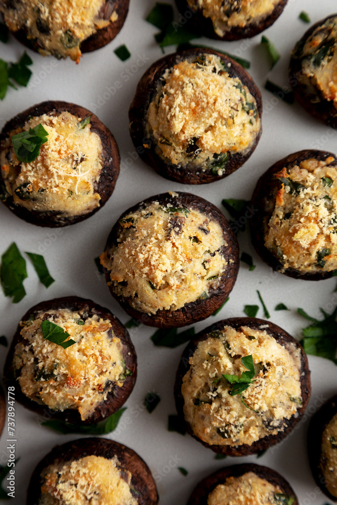 Homemade Garlic Parmesan-Stuffed Mushrooms on a plate, top view. Close-up. Homemade Garlic Parmesan-Stuffed Mushrooms on a plate, top view. Close-up.
