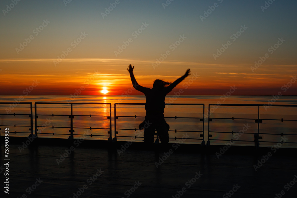 Fototapeta premium Girl silhouette in magical sunset over the Gulf of Finland, Baltic sea.