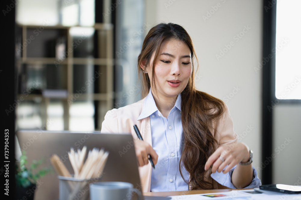 Happy asian young businesswoman excited with laptop at office workplace, Excited happy Asian woman.