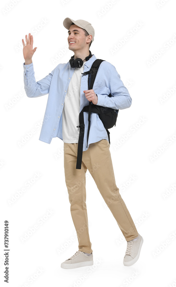 Young man with cap, headphones and backpack waving hand on white background Young man with cap, headphones and backpack waving hand on white background