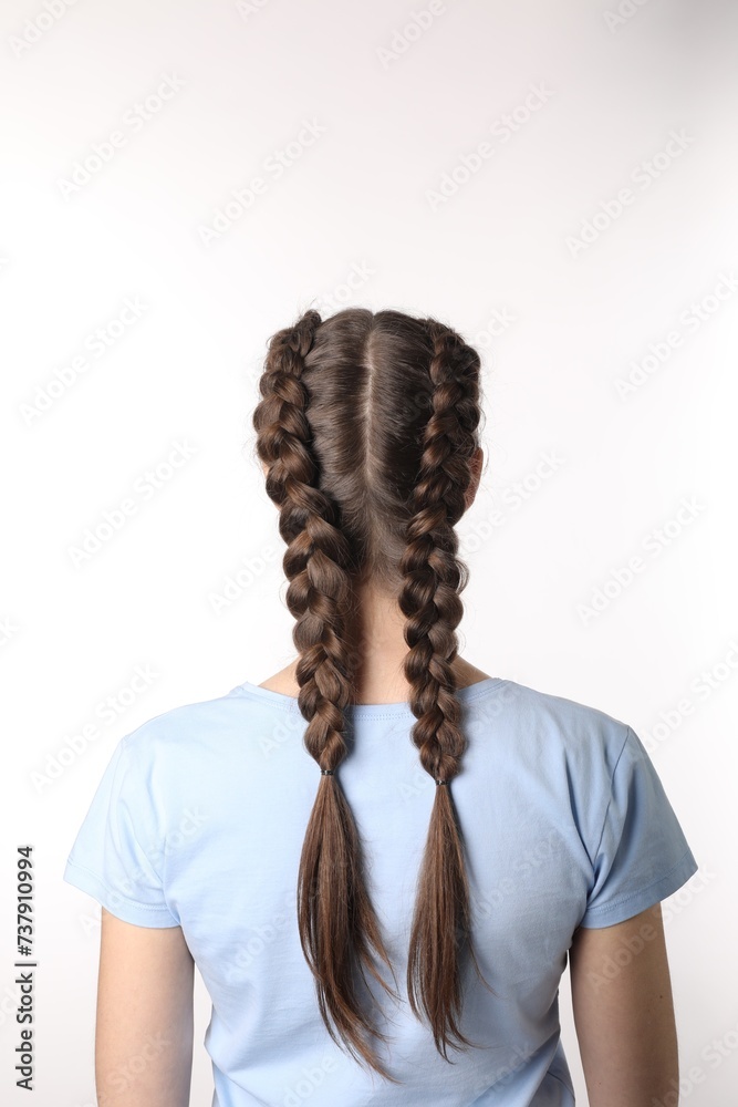 Woman with braided hair on light background, back view Woman with braided hair on light background, back view
