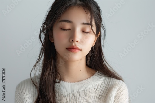 beautiful young Asian girl posing gracefully in warm, soft daylight
