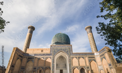 Facade of the Gur Emir mausoleum with mosaic brick walls in the ancient city of Samarkand in Uzbekistan, oriental architecture photo