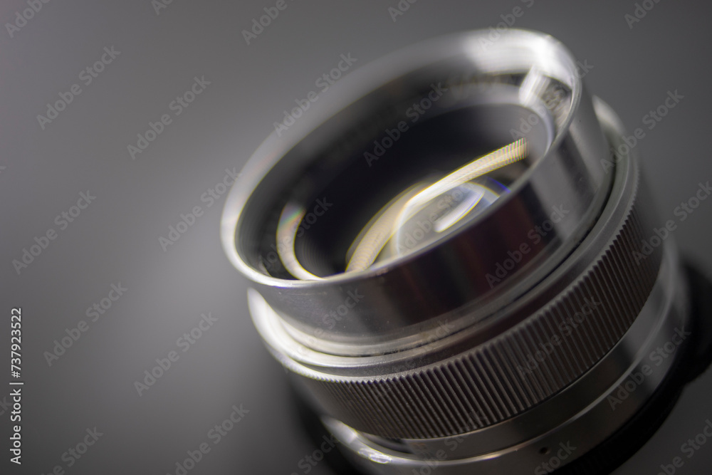 Close-up of camera,Close-up of hand holding camera lens,Old vintage camera placed on a blurred background. Close-up of camera,Close-up of hand holding camera lens,Old vintage camera placed on a blurred background.