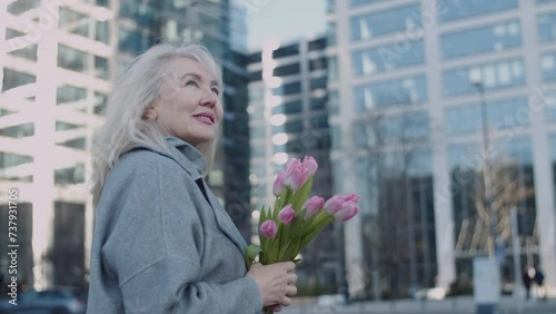 A portrait of a senior woman in cityscape