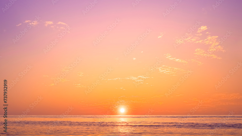Romantic sunset sky background over sea with golden fluffy cloud on idyllic orange evening sky and sunlight reflection on water surface, beautiful nature tranquil seascape in minimal style