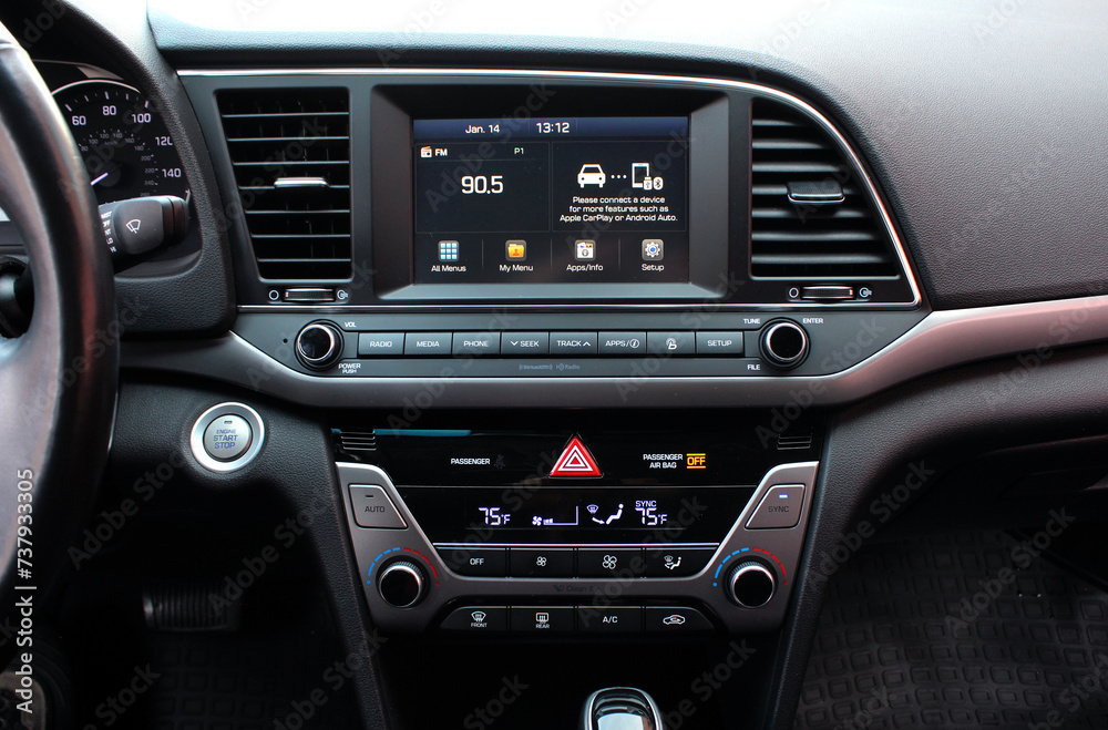 Modern car dashboard. Screen multimedia system. Interior of a modern luxury car. Control panel in a modern car. Car climate control close up. 