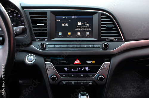 Modern car dashboard. Screen multimedia system. Interior of a modern luxury car. Control panel in a modern car. Car climate control close up.  photo