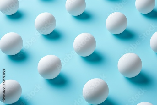 White eggs arranged in a row on blue background with one egg in the middle, isolated on colorful minimalistic backdrop