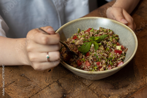 Tabbouleh salad in a bowl on a wooden table .quinoa salad