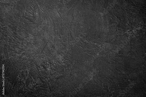 Black background with imitation of concrete or stone. beautiful texture decorative Venetian stucco for backgrounds.