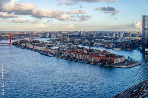 Rotterdam, The Netherlands, February 12, 2024: aerial view of the river Nieuwe Maas with Noordereiland neighbourhood around sunset on a winter day