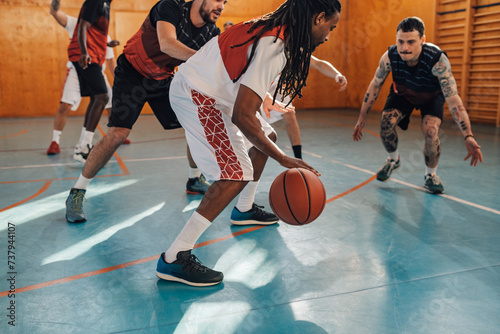 Interracial sportsman dribbling a ball on basketball training. © Zamrznuti tonovi